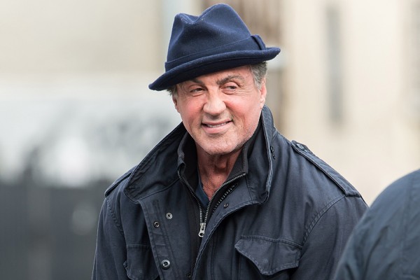 Sylvester Stallone takes time to play with a neighborhood kid on set of the new Rocky movie "Creed" in Philadelphia, PA